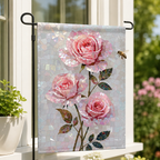 Pink rose mosaic garden flag displayed beside a bright window, with a bee and soft garden greenery in the background.