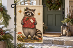 Raccoon Christmas Gift Printed Garden Flag, lifestyle view 3: Closer view of the flag on its separate black L-shaped stake near a porch post, the real cloth top sleeve threading over the horizontal bar, print clearly readable.