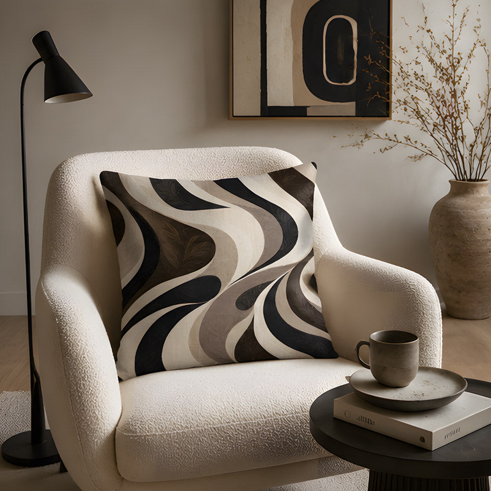 A retro abstract wavy lines accent pillow styled on a stylish cream bouclé armchair, paired with a sleek black floor lamp and a dark side table with a ceramic coffee mug.