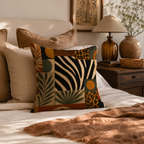 Modern safari themed pillow cover with zebra and cheetah patterns styling a warm, neutral-toned bed.