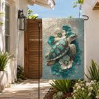 Sea turtle floral garden flag displayed in a sunny coastal courtyard with white walls, wood gate, tropical plants, and soft blue tones.