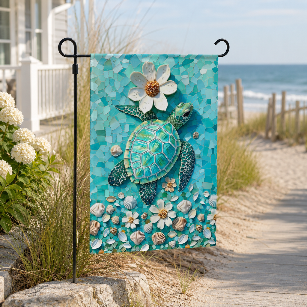 Sea turtle mosaic garden flag displayed beside a sunny beach walkway