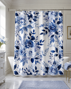 Centered view of a romantic blue and white rose patterned shower curtain hanging in a bright luxury bathroom with blue decor accents.