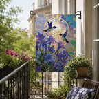 Stained glass hummingbird garden flag hanging on a flower-filled balcony