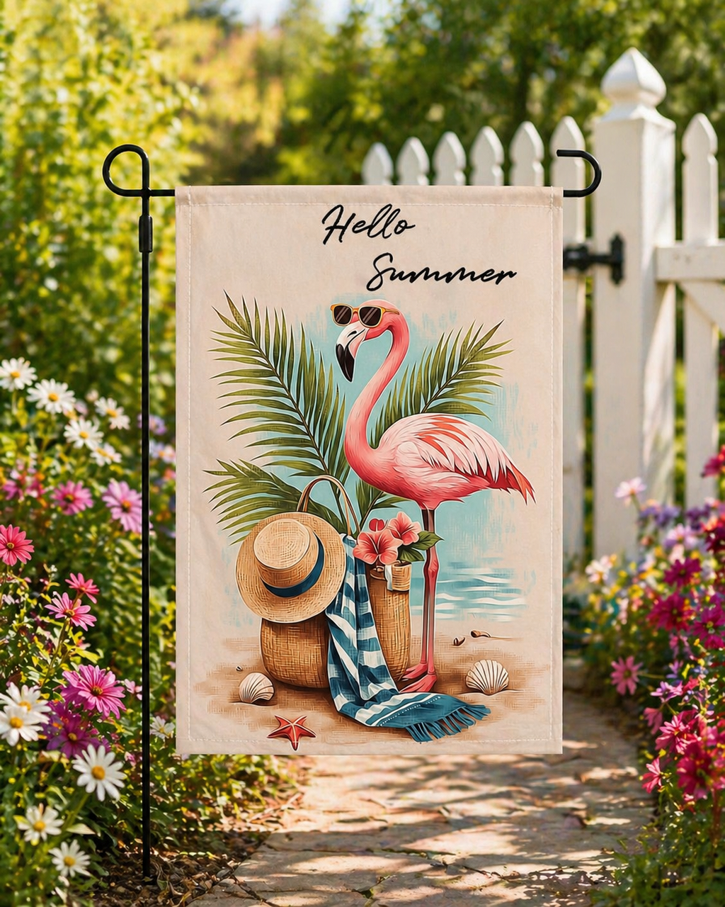 Sunlit flamingo getaway garden flag displayed beside a white picket fence.