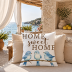 Home Sweet Home blue bird pillow cover styled on a coastal sofa.