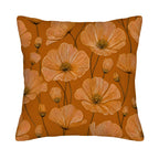 A terracotta orange pillow cover featuring a detailed botanical poppy flower pattern isolated on a white background.