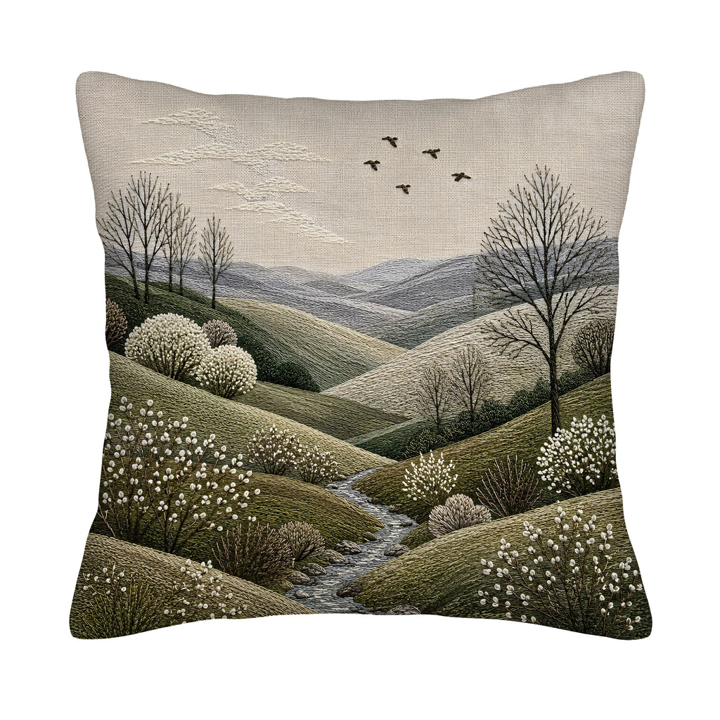 A square throw pillow cover isolated on a white background, featuring a highly detailed faux-embroidery print of a serene countryside valley, winding river, and white blossoming trees under a soft grey sky with flying birds.