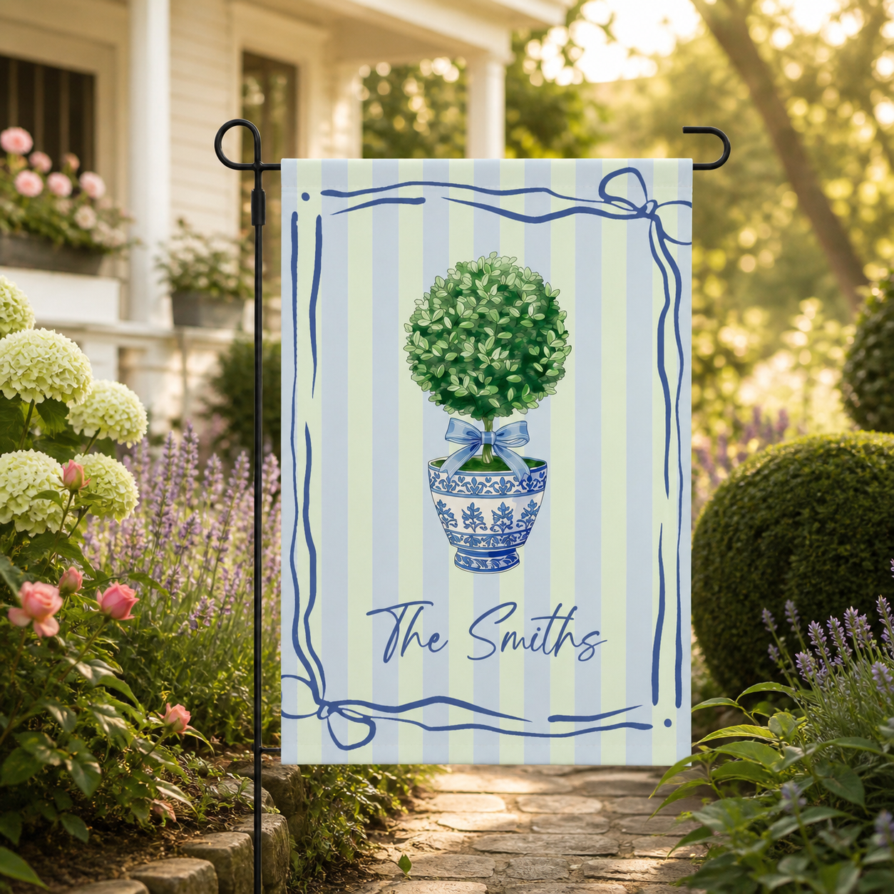 Topiary garden flag displayed in a sunny summer garden pathway