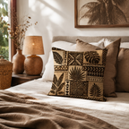 Earthy tones tribal leaf print pillow cover decorating a beautifully styled, warm neutral bedroom.
