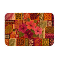 A rectangular doormat with a tropical hibiscus mosaic pattern featuring vibrant pink flowers and palm leaves.