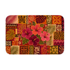 A rectangular doormat with a tropical hibiscus mosaic pattern featuring vibrant pink flowers and palm leaves.