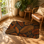 Tropical palm leaves accent rug on a hardwood floor next to a leather armchair.