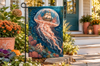 Underwater Ghost Ship Printed Garden Flag, lifestyle view 4: One flag on its separate black garden stake in a mailbox garden with restrained October seasonal planting, wide but product-led welcoming suburban scene.