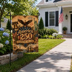 Patriotic celebrating America 250 garden flag displayed along a stone walkway with the American flag on the house.