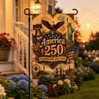 Patriotic America 250 garden flag standing in front of a house during sunset with celebratory fireworks in the background.