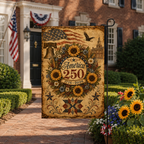 Historic 1776 to 2026 celebrating garden flag standing on a metal post along a brick walkway in front of a brick house.