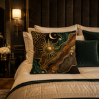 An ornate vintage astrology-themed accent pillow with a golden sun and moon pattern arranged on a luxury bed, featuring a dark brown tufted wall panel and a warm bedside lamp.