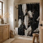 A black and white cattle herd pattern shower curtain in a cozy rustic bathroom with light oak vanity, pampa grass vase, woven hamper, and natural sunlight.