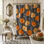 A vintage-inspired orange and yellow poppy flower shower curtain hanging beside a classic clawfoot bathtub in a chic french provincial bathroom with bronze mirror and roses.