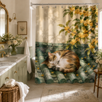 Watercolor style shower curtain depicting a sleeping cat on green roof tiles, complementing an elegant sage green vanity and white floral arrangements.