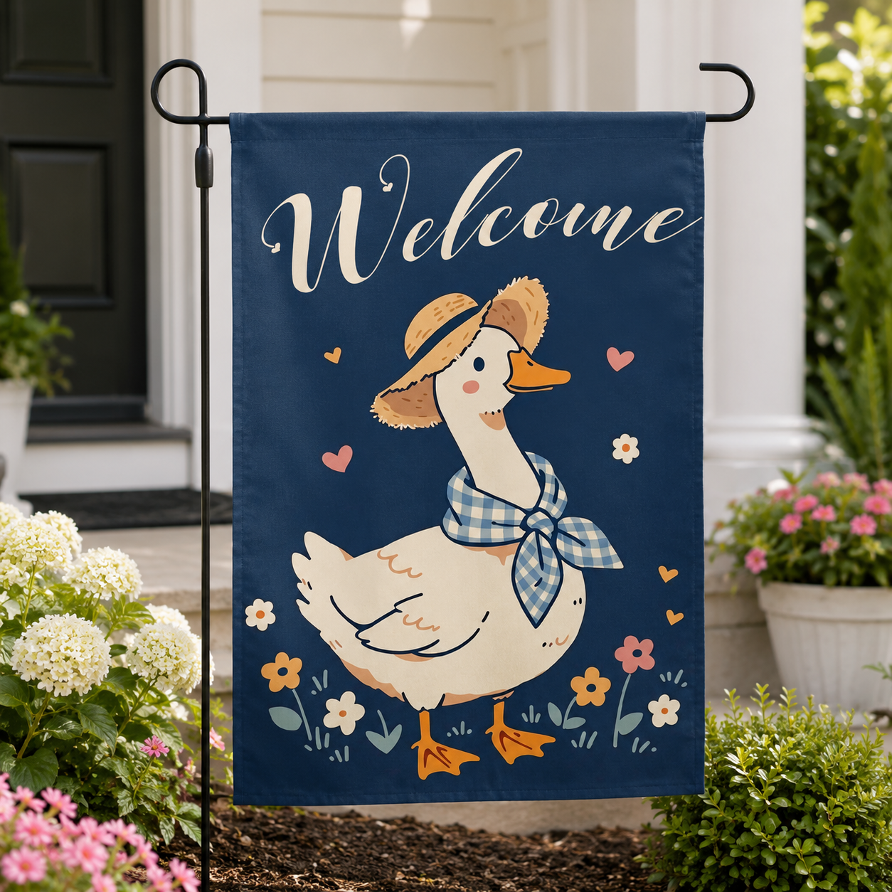 Welcome goose garden flag shown close up by a front entry.