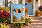 Witch Laundry Line Printed Garden Flag, lifestyle view 4: One flag on its separate black garden stake in a mailbox garden with restrained October seasonal planting, wide but product-led welcoming suburban scene.