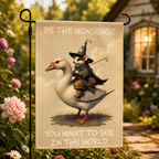 Wizard possum goose garden flag shown close up among flowers.